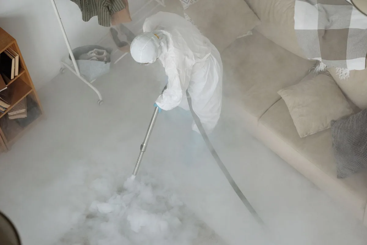 Biohazard cleanup technician in protective equipment, Freeport Manor, Sacramento, CA